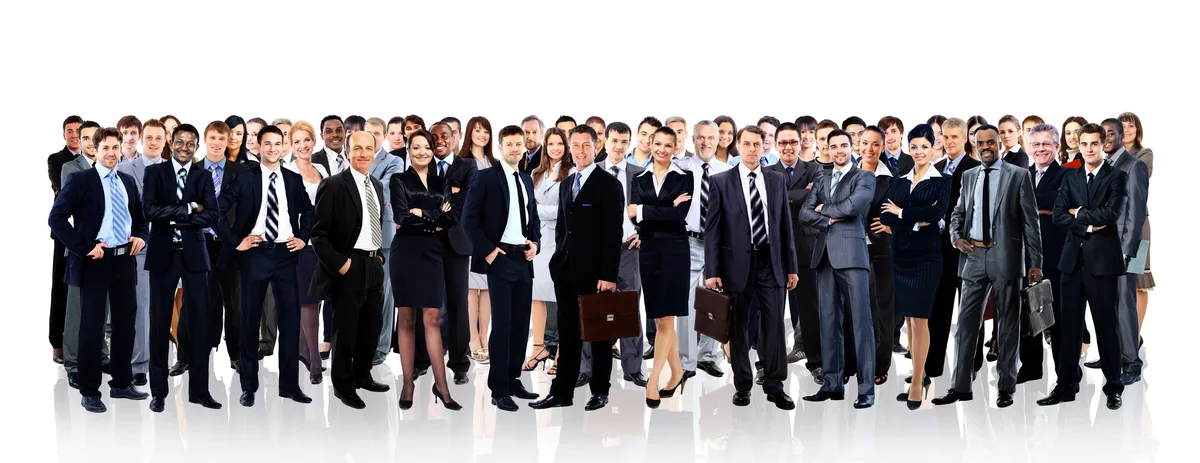 A large, diverse group of people in business suits standing together in rows against a white background.