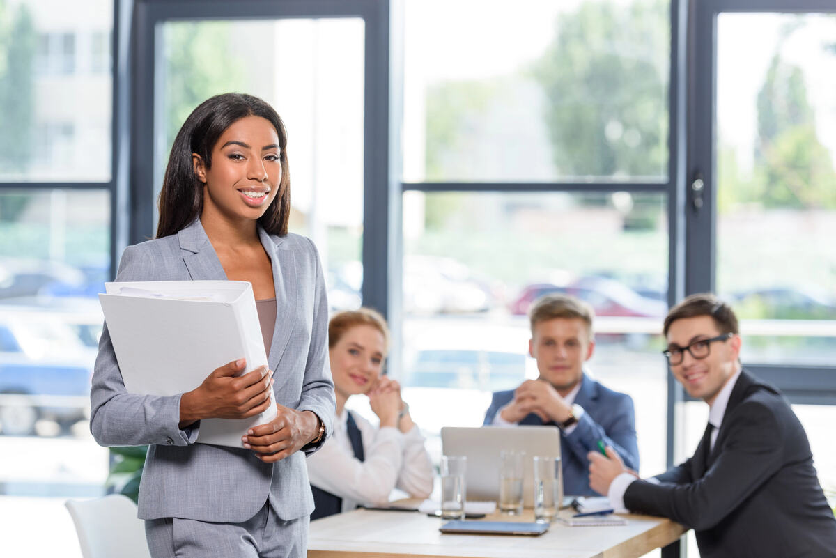 A diverse group of young lawyers at a desk in a Canadian law office.