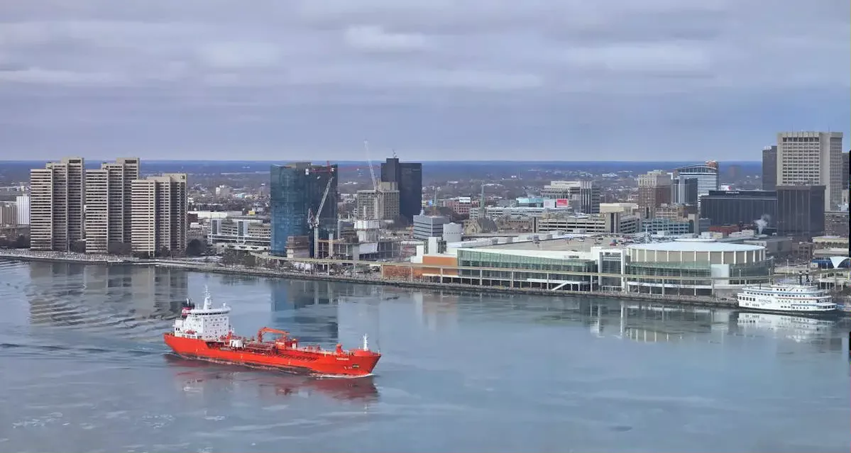 Windsor, Ontario waterfront with a red cargo ship in the water
